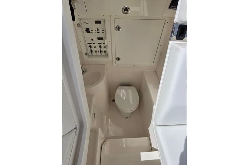 Slide: The Image of 2023 SeaVee 340B boat interior with compact bathroom and control panel. - 16