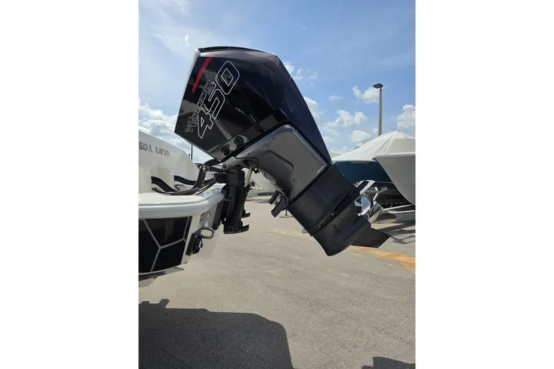 Slide: The Image of 2023 SeaVee 340B boat with powerful 450 outboard engine, parked under a clear sky. - 3