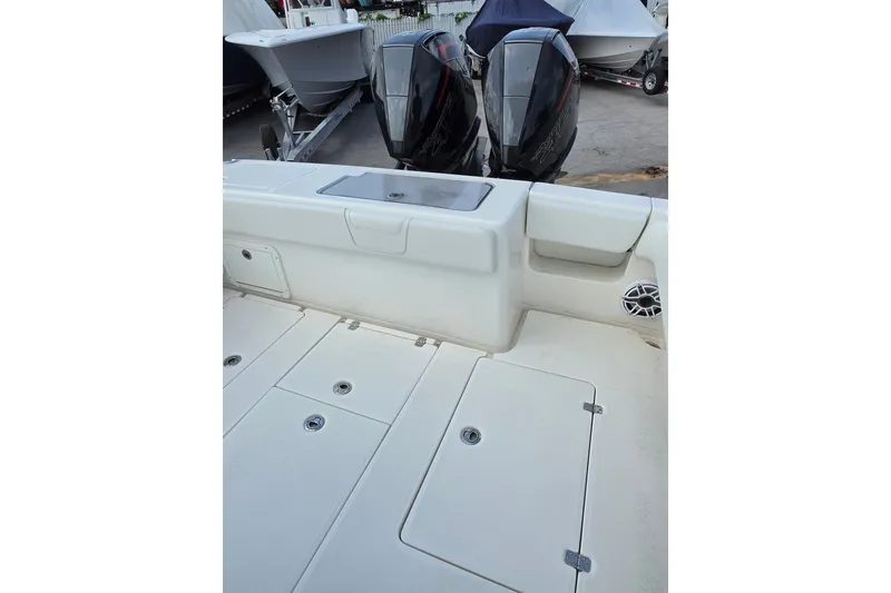 Slide: The Image of 2023 SeaVee 340B boat deck with dual outboard engines and storage compartments. - 13