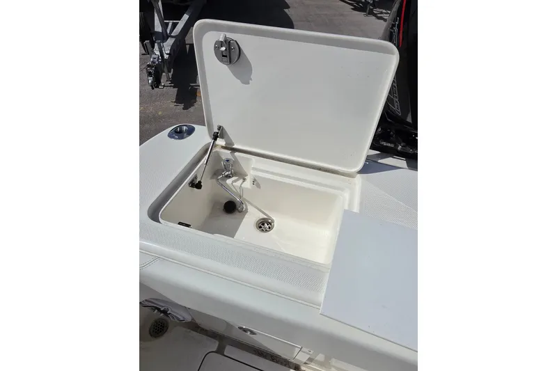 Slide: The Image of Open storage compartment on 2023 SeaVee 340B boat, featuring a clean, white interior. - 15