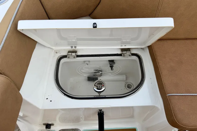 Slide: The Image of Open storage compartment on 2024 Sea Hunt Ultra 275SE boat with cushioned seating. - 9