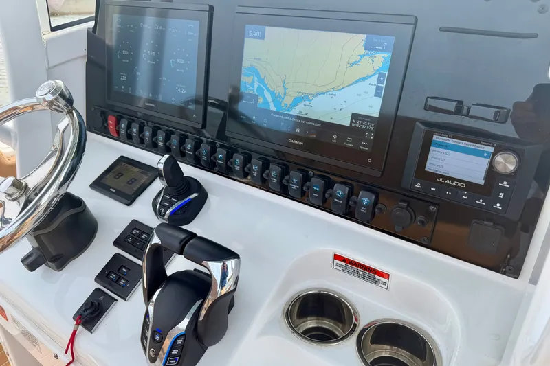 Slide: The Image of 2024 Sea Hunt Ultra 275SE dashboard with advanced navigation and control systems. - 13