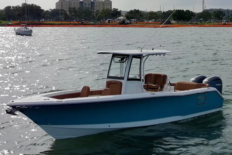Slide: The Image of 2024 Sea Hunt Ultra 275SE boat on water, featuring sleek design and twin engines. - 3