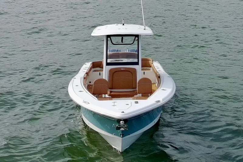 Slide: The Image of 2024 Sea Hunt Ultra 275SE boat on calm water, front view. - 21