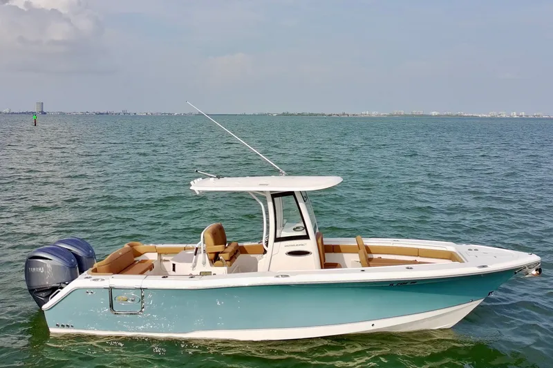 The Image of 2024 Sea Hunt Ultra 275SE boat on calm water, featuring sleek design and dual engines. - 0