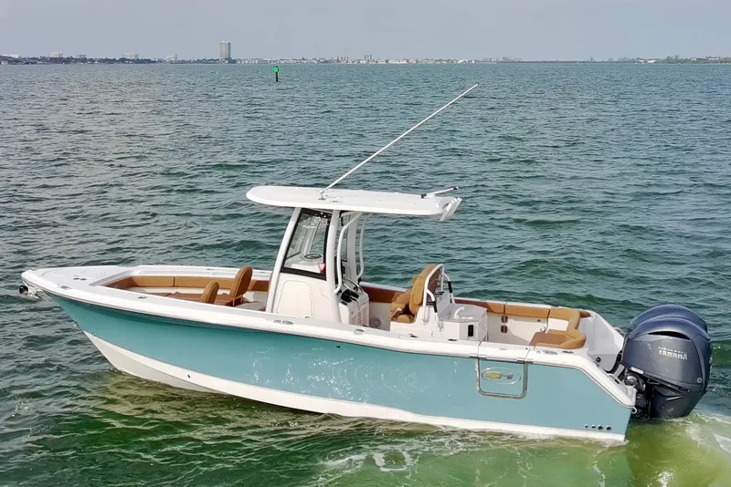 Slide: The Image of 2024 Sea Hunt Ultra 275SE boat on open water, featuring sleek design and powerful engine. - 6