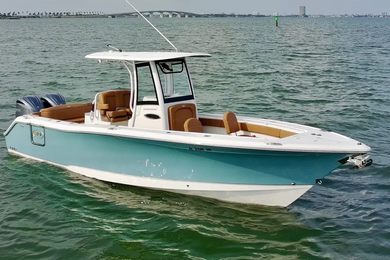 Slide: The Image of 2024 Sea Hunt Ultra 275SE boat on calm water, featuring sleek design and dual engines. - 1