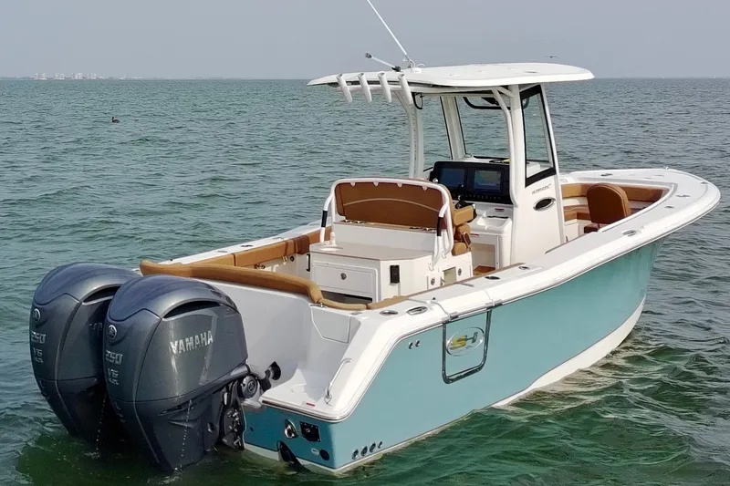 Slide: The Image of 2024 Sea Hunt Ultra 275SE boat with twin Yamaha engines on open water. - 4