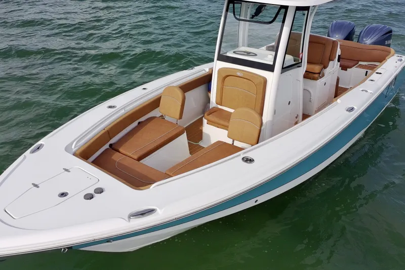 Slide: The Image of 2024 Sea Hunt Ultra 275SE boat on water, featuring sleek design and comfortable seating. - 20