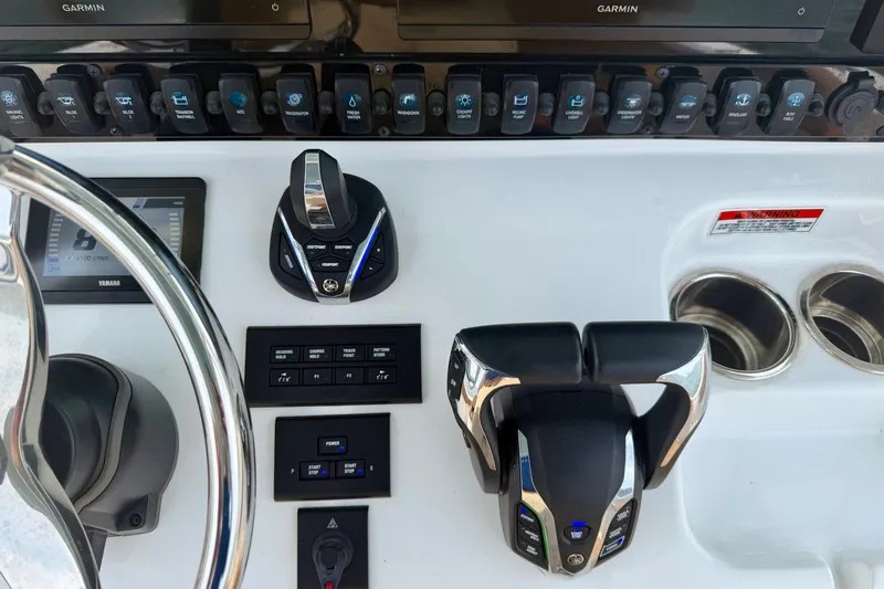 Slide: The Image of 2024 Sea Hunt Ultra 275SE helm with advanced controls and Garmin navigation system. - 14
