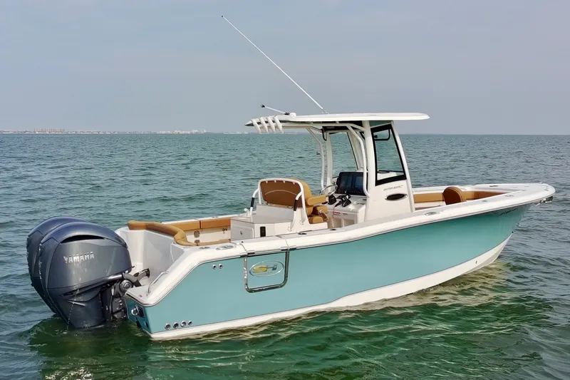 Slide: The Image of 2024 Sea Hunt Ultra 275SE boat on calm water, featuring Yamaha outboard motor. - 5