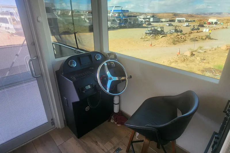 Slide: The Image of Cockpit view of Adonia Legacy Trip #15, showcasing steering wheel and desert landscape outside. - 15