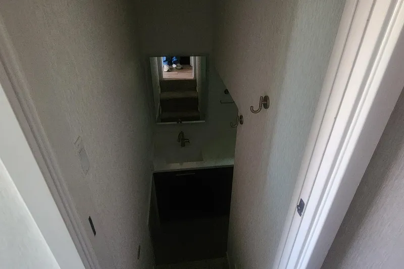 Slide: The Image of Narrow hallway with hooks, mirror, and sink in Adonia Legacy Trip #15, 2022. - 9