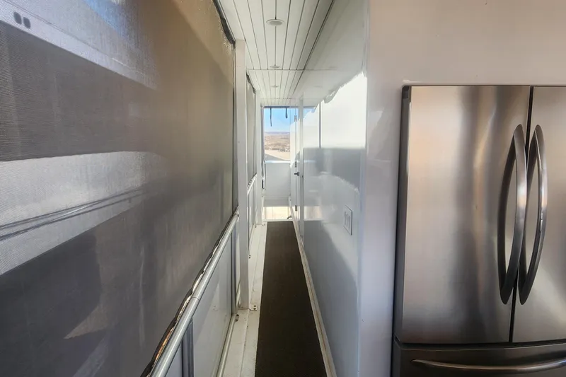 Slide: The Image of Narrow hallway on Adonia Legacy Trip #15, featuring stainless steel refrigerator, 2022. - 19