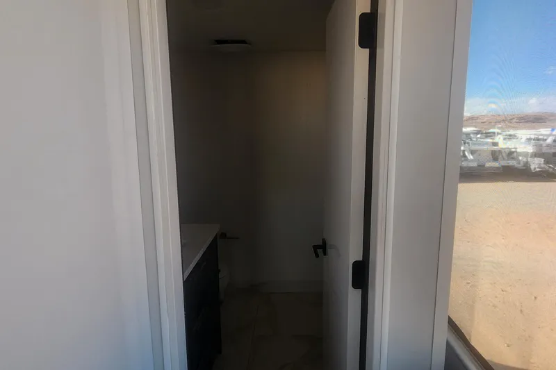 Slide: The Image of Interior view of Adonia Legacy Trip #15 bathroom, featuring a partially open door and outdoor scenery. - 18