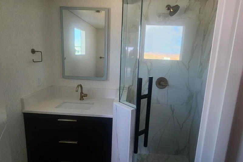 Slide: The Image of Modern bathroom with marble shower, sleek vanity, and gold fixtures in Adonia Legacy Trip #15. - 14