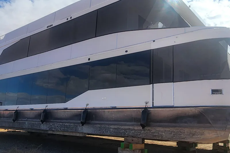 Slide: The Image of Luxury yacht Adonia Legacy Trip #15, 2022 model, docked on wooden supports. - 3