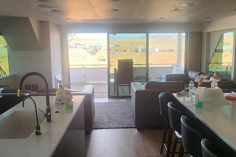 Slide: The Image of Modern kitchen and living area in Adonia Legacy Trip #15, 2022, with scenic outdoor view. - 6