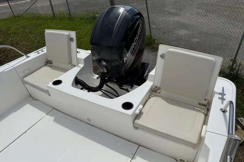 Slide: The Image of 2019 Boston Whaler 210 Montauk boat with Mercury engine and seating area. - 8