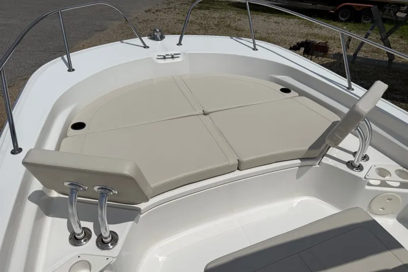 Slide: The Image of 2019 Boston Whaler 210 Montauk boat interior with cushioned seating and stainless steel railings. - 10