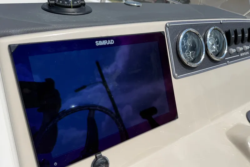Slide: The Image of Dashboard of a 2019 Boston Whaler 210 Montauk with Simrad display and gauges. - 14