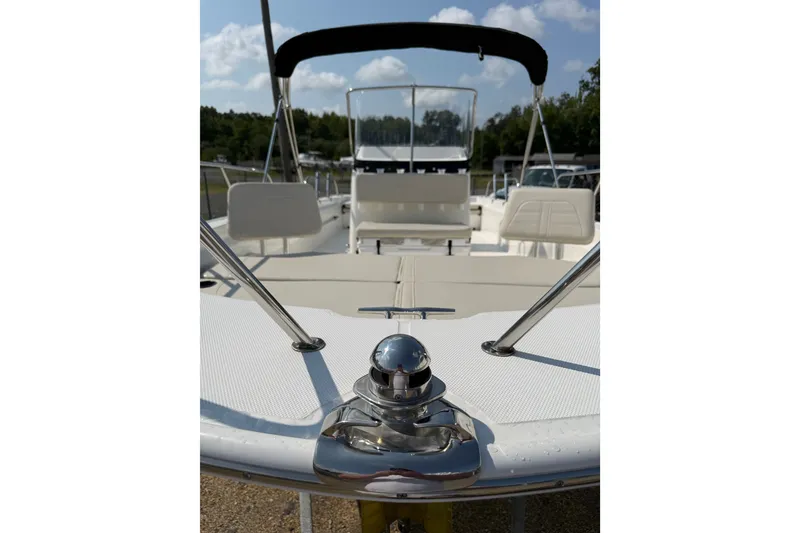 Slide: The Image of 2019 Boston Whaler 210 Montauk boat deck with seating and canopy under blue sky. - 5