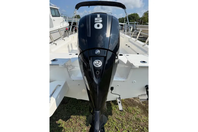 Slide: The Image of 2019 Boston Whaler 210 Montauk boat with powerful outboard motor, docked outdoors. - 2