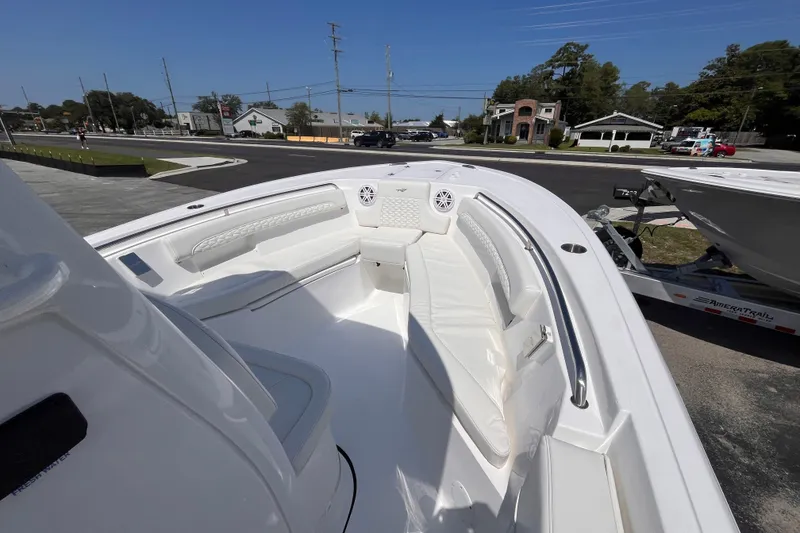 Slide: The Image of 2027 Tidewater 232 LXF boat interior with white seating and modern design. - 13