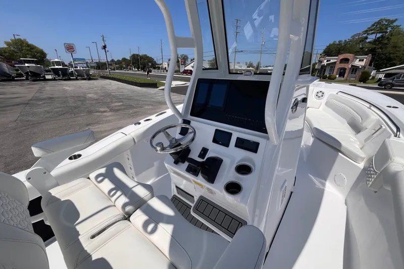 Slide: The Image of 2027 Tidewater 232 LXF boat interior with modern helm and seating, showcasing sleek design. - 16