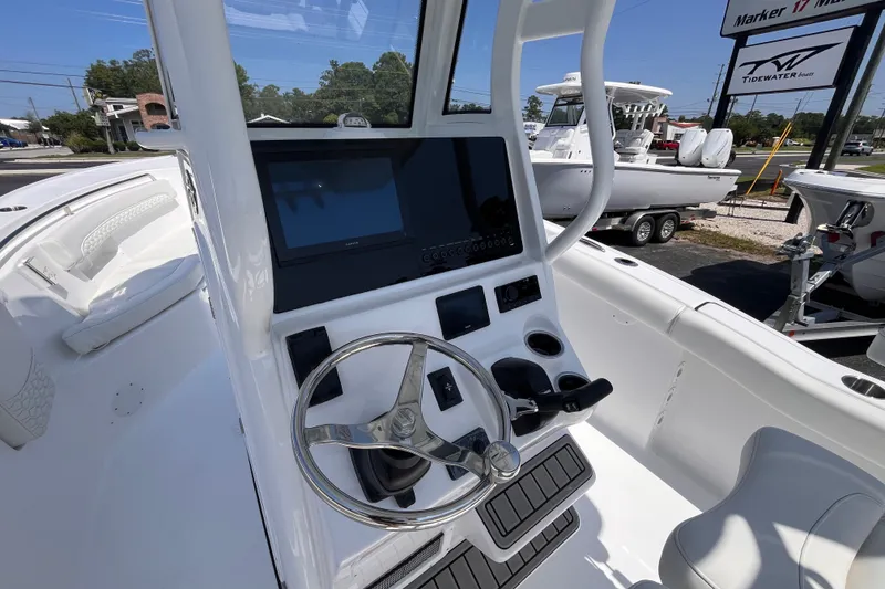 Slide: The Image of 2027 Tidewater 232 LXF boat dashboard with steering wheel and navigation display. - 8