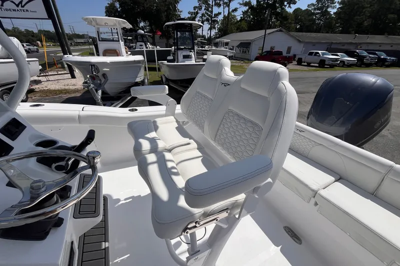 Slide: The Image of 2027 Tidewater 232 LXF boat interior with white seating and steering wheel. - 7