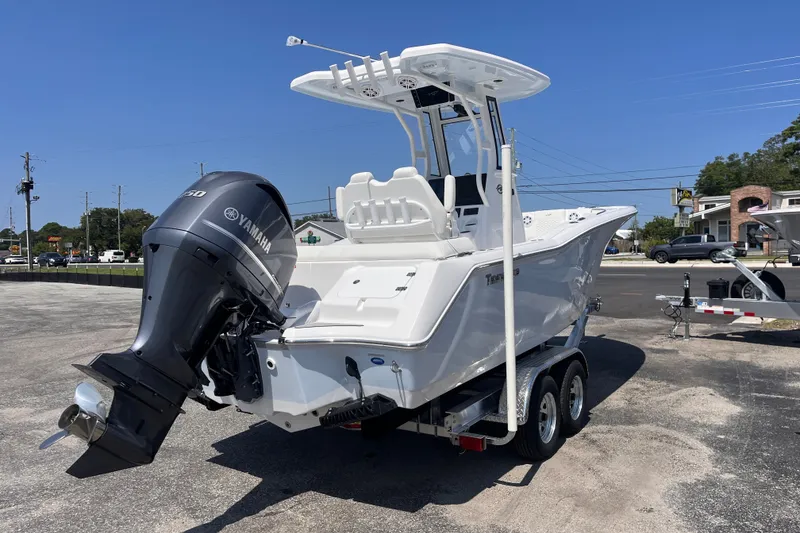 Slide: The Image of 2027 Tidewater 232 LXF boat with Yamaha engine on trailer, parked outdoors. - 4