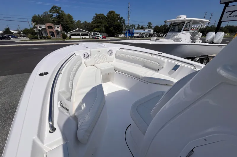 Slide: The Image of 2027 Tidewater 232 LXF boat interior with white seating and modern design. - 11