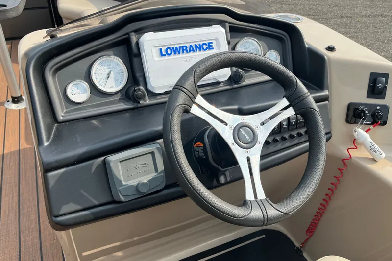 Slide: The Image of 2024 Bentley Pontoons Legacy 240 Navigator dashboard with steering wheel and Lowrance display. - 8
