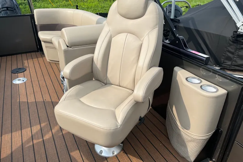 Slide: The Image of Luxurious seating on 2024 Bentley Pontoons Legacy 240 Navigator with beige upholstery and cup holders. - 9