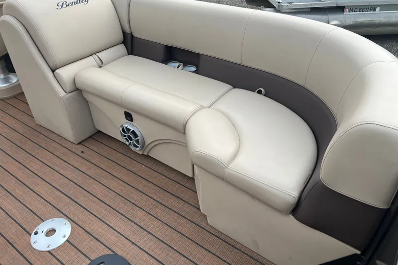 Slide: The Image of 2024 Bentley Pontoons Legacy 240 Navigator interior seating with beige upholstery and speaker. - 5