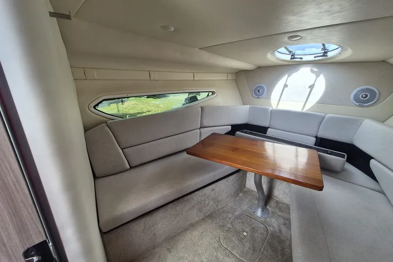 Slide: The Image of Interior of 2022 Regal 26 XO boat with cozy seating and wooden table. - 15