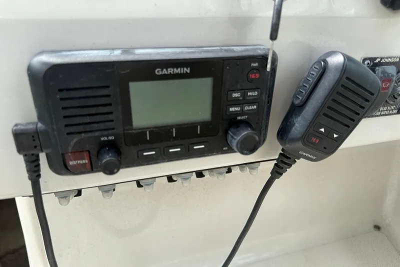 Slide: The Image of Garmin marine radio on 2022 Regal 26 XO boat dashboard with microphone. - 5