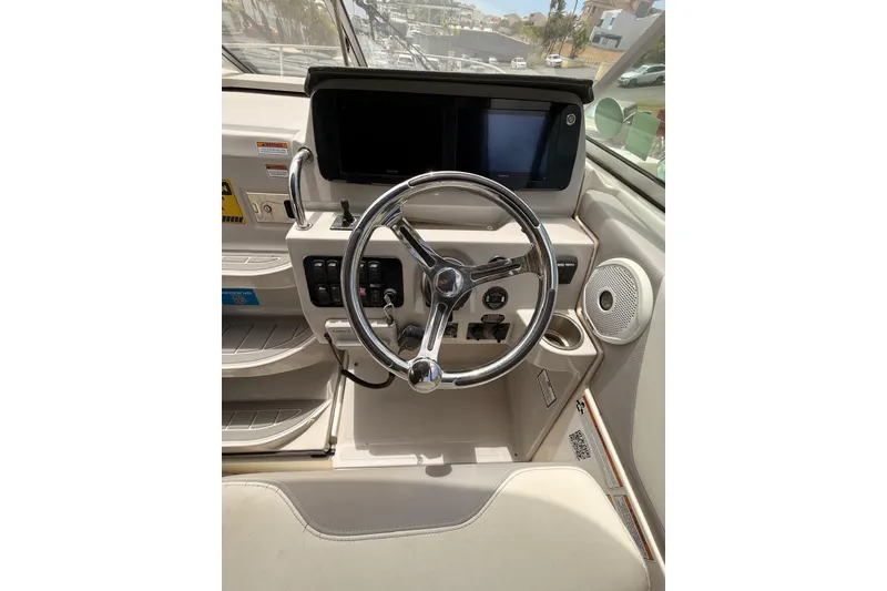 Slide: The Image of Steering console of 2022 Regal 26 XO boat with modern controls and displays. - 19