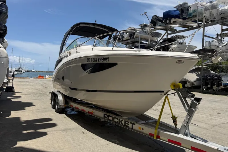 Slide: The Image of 2022 Regal 26 XO boat on trailer at marina, sunny day. - 12