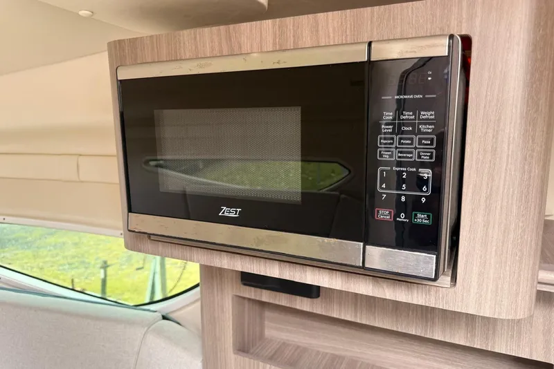 Slide: The Image of Microwave in 2022 Regal 26 XO boat interior, featuring a Zest brand appliance. - 9