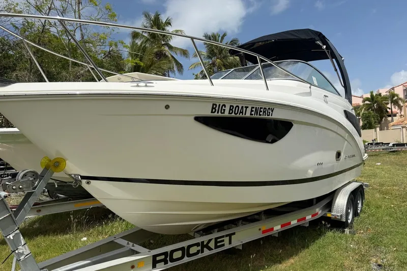 Slide: The Image of 2022 Regal 26 XO boat on trailer, labeled "Big Boat Energy," parked on grass. - 3