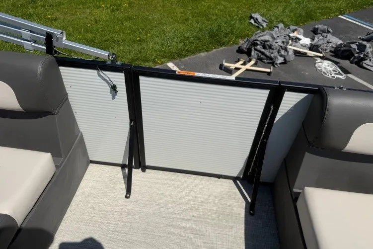 Slide: The Image of 2026 Princecraft Jazz 170 boat interior with open gate, gray seating, and outdoor setting. - 13