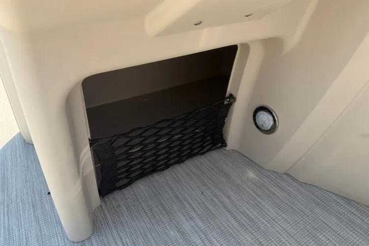 Slide: The Image of Storage compartment in 2026 Princecraft Jazz 170 boat with netting and ventilation. - 12