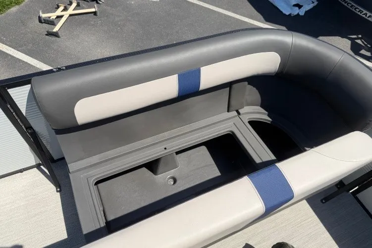 Slide: The Image of 2026 Princecraft Jazz 170 boat interior with gray and blue seating, open storage compartment. - 15