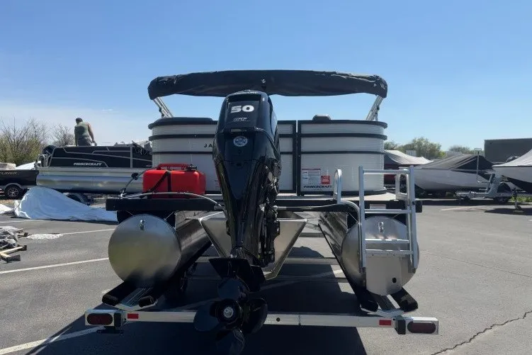 Slide: The Image of 2026 Princecraft Jazz 170 pontoon boat with 50 HP engine, parked on a trailer. - 6