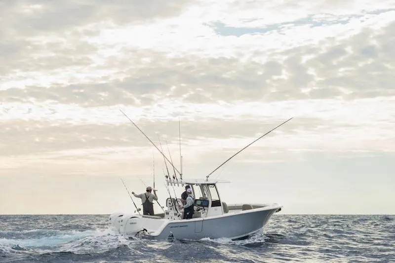 Slide: The Image of 2027 Sportsman Open 262 Center Console boat on open sea under cloudy sky. - 6
