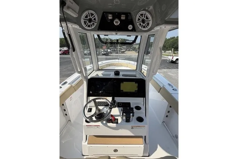 Slide: The Image of 2027 Sportsman Open 262 Center Console boat dashboard with steering wheel and navigation controls. - 12