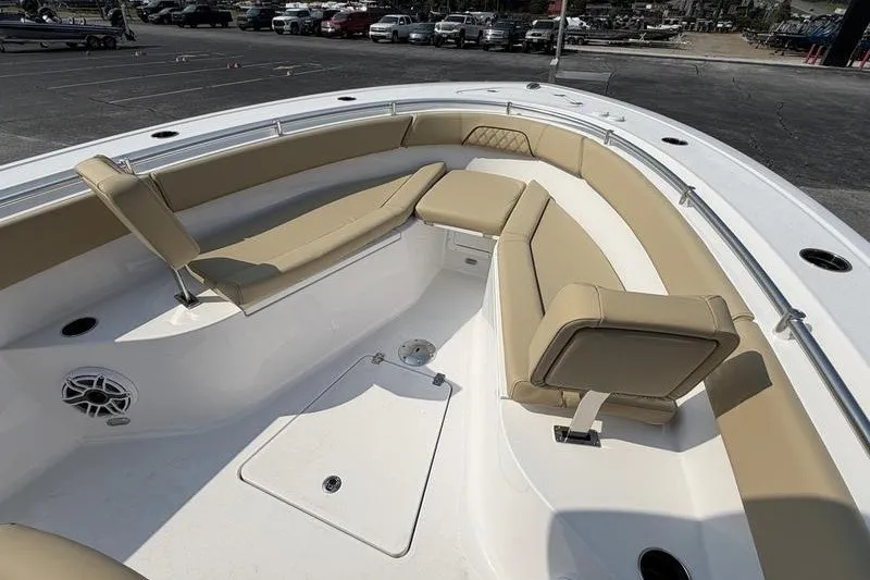 Slide: The Image of 2027 Sportsman Open 262 Center Console boat with tan seating in a parking lot. - 3