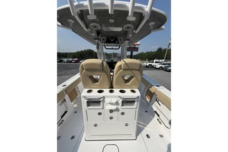 Slide: The Image of 2027 Sportsman Open 262 Center Console boat interior with beige seating and storage compartments. - 8